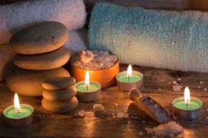 Appealing photo of candles, massage stones and towels | Ipswich based massage therapist